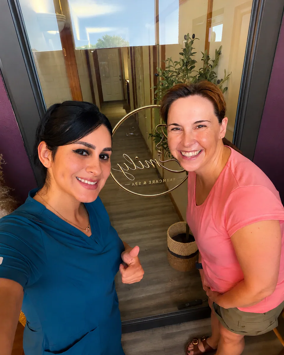 Emily standing with a client at the entrance to her skincare studio.