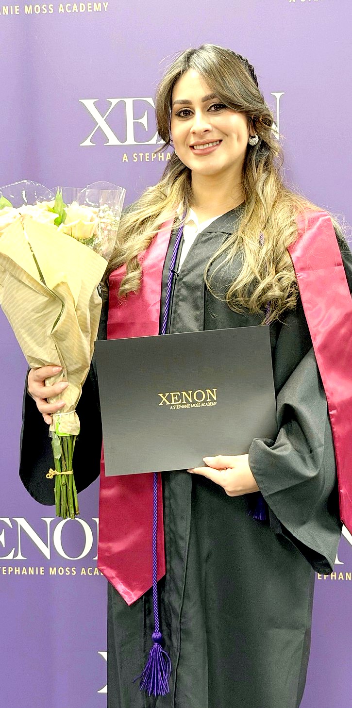 Emily Menjivar celebrating professional esthetics training at Xenon Academy.