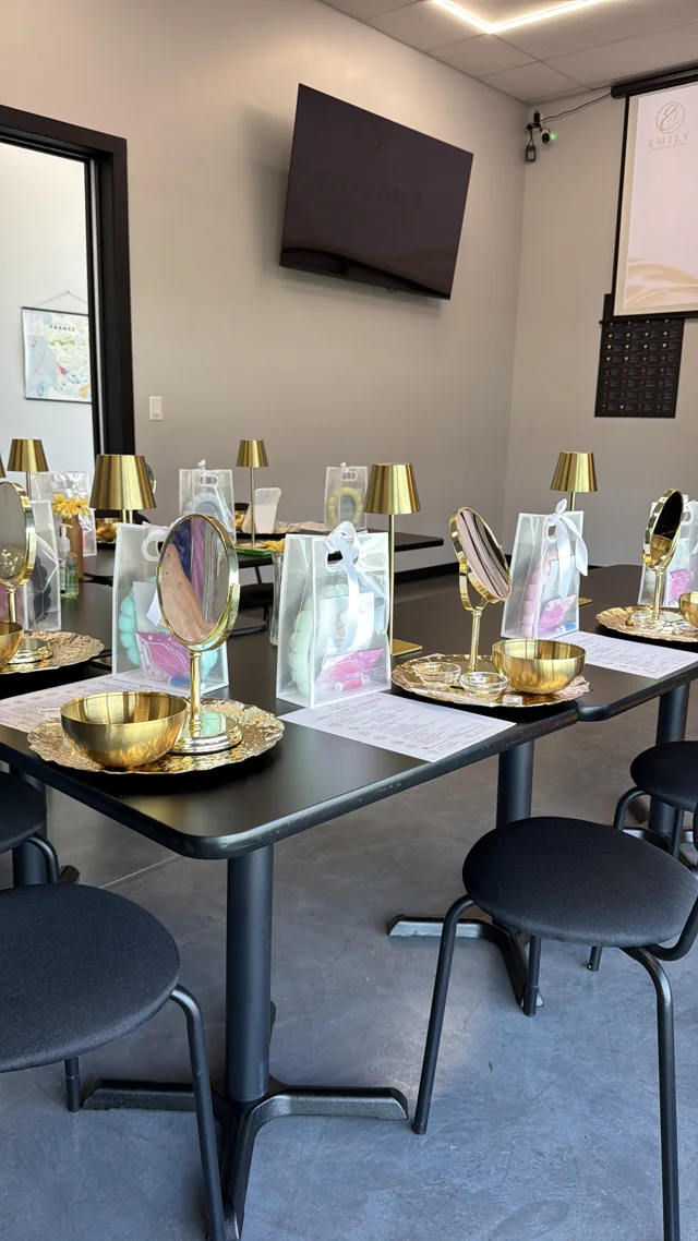 Tables set with mirrors, gold bowls, lights and skincare kits.
